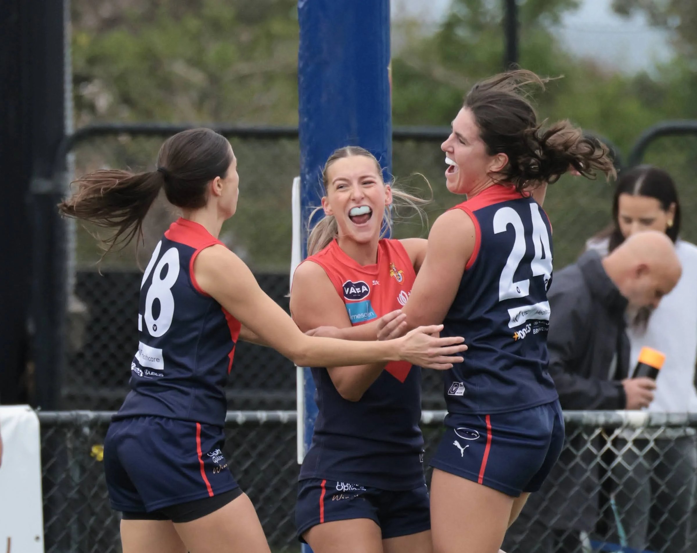 Old Brighton women celebrate a goal together