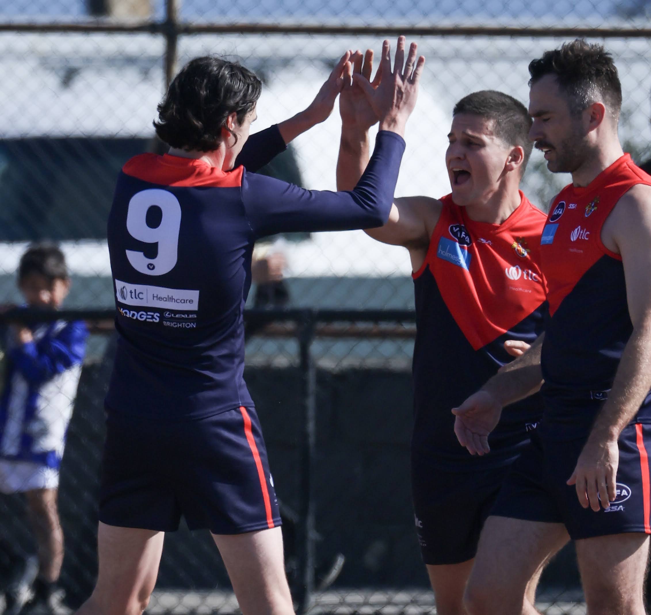 Old Brighton players high five after a goal