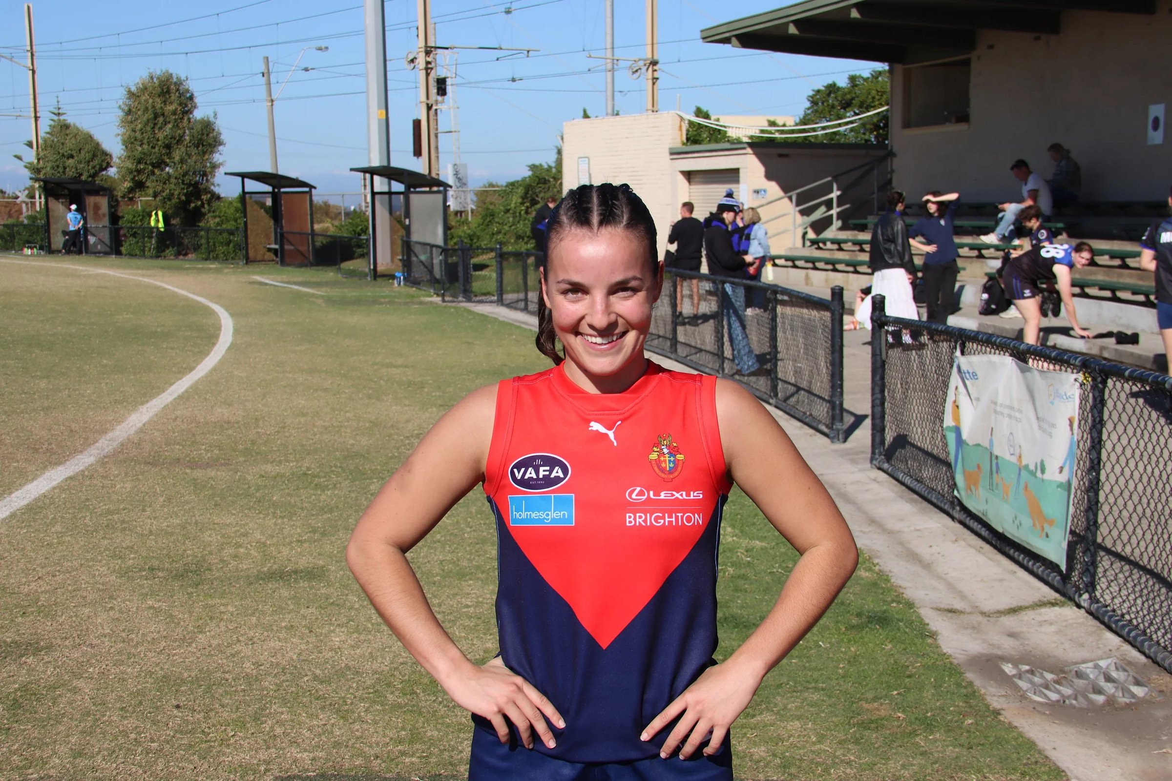 An Old Brighton women's player in the navy and red guernsey